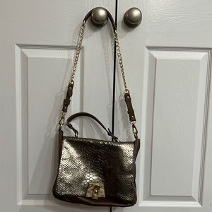 Gold and brown purse with gold and sone closure. Double handle straps.